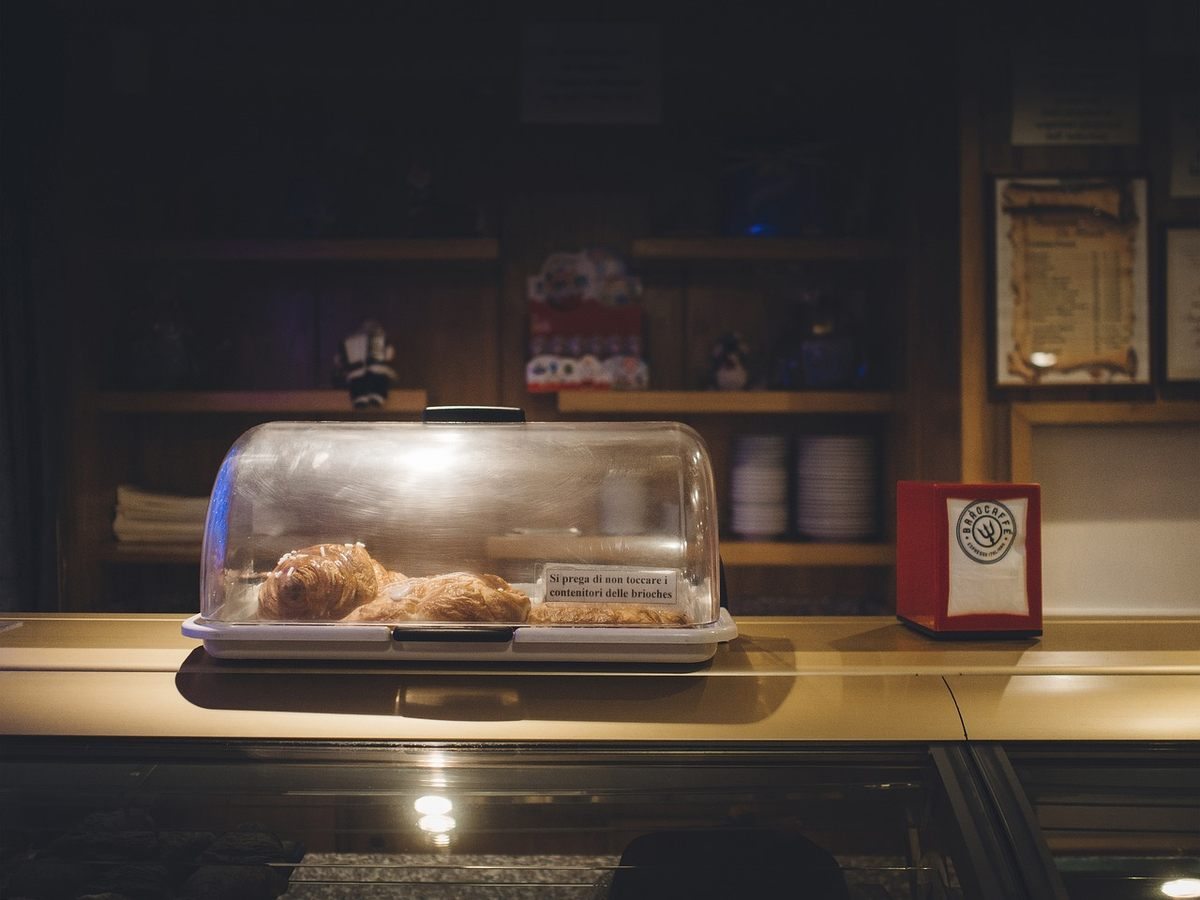 Vitrine éclairée d'une boulangerie avec pâtisseries et comptoir de service Vitrine éclairée d'une boulangerie avec pâtisseries et comptoir de service