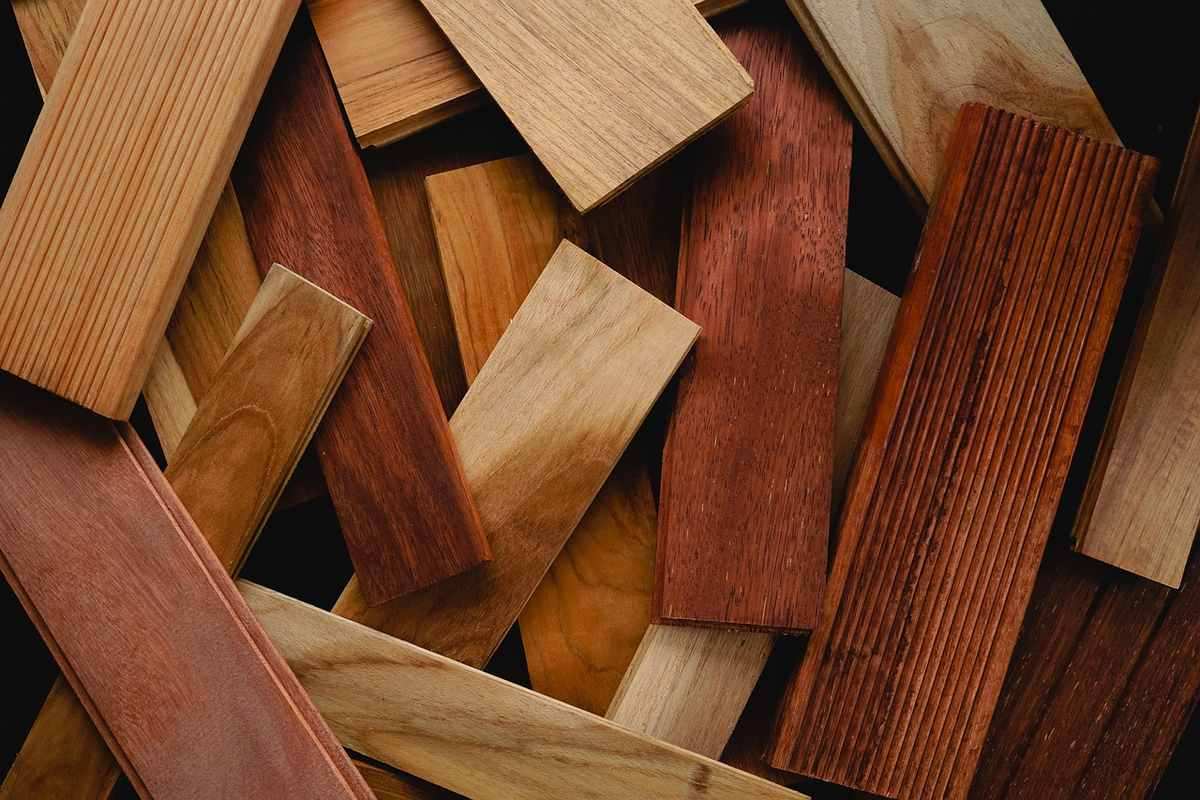 Différentes lames de bois posées en vrac, montrant diverses couleurs et finitions de grain Différentes lames de bois posées en vrac, montrant diverses couleurs et finitions de grain