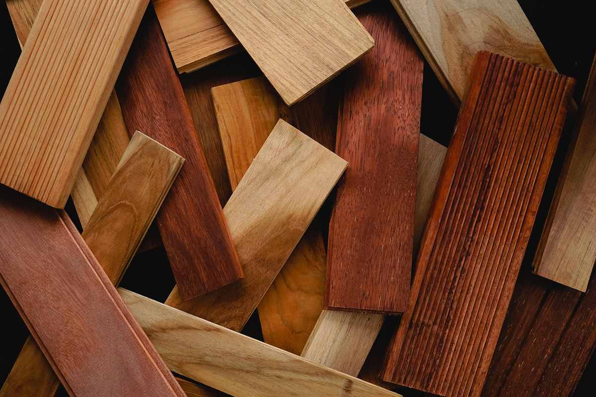 Différentes lames de bois posées en vrac, montrant diverses couleurs et finitions de grain Différentes lames de bois posées en vrac, montrant diverses couleurs et finitions de grain